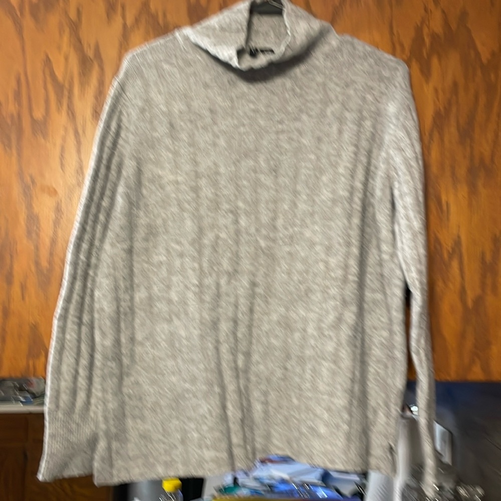 Gray sweater, slight neck coverage